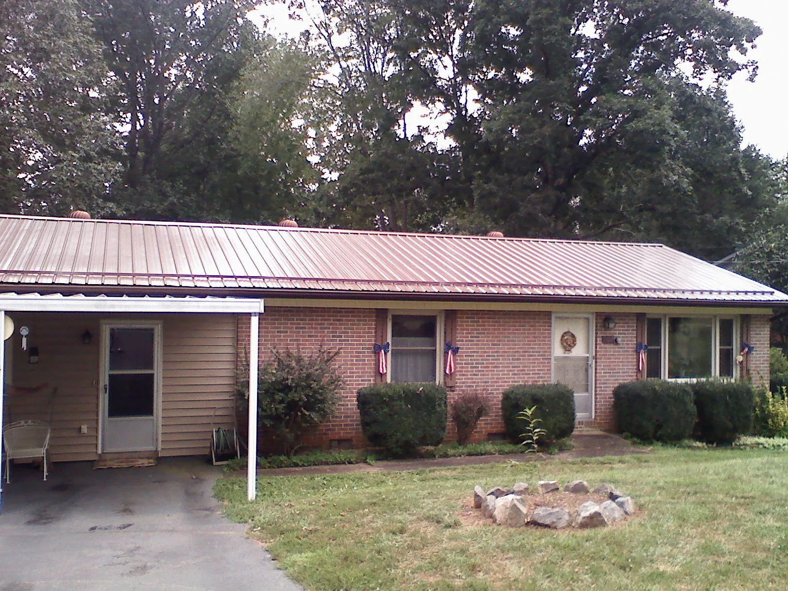 Bronze metal roof and carport on a brick ranch home — Roof Repair work by our crew in Pomeroy