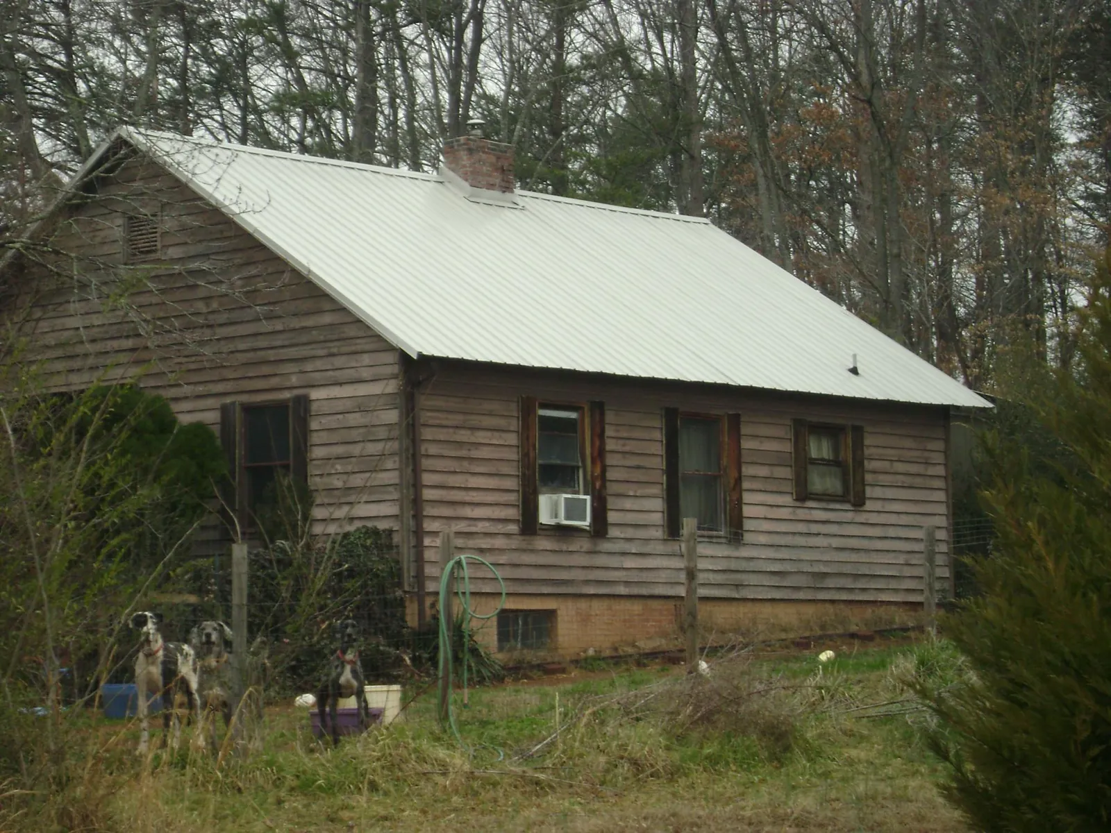 White metal roof on an old wood sided farmhouse, from a Metal Roof Installation job in Pomeroy